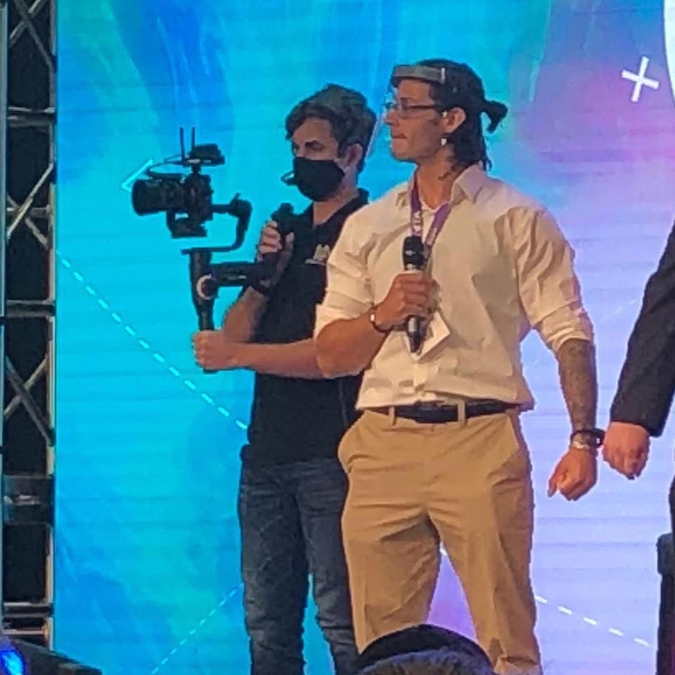 Charlie speaking on stage at Kris Krohn's conference